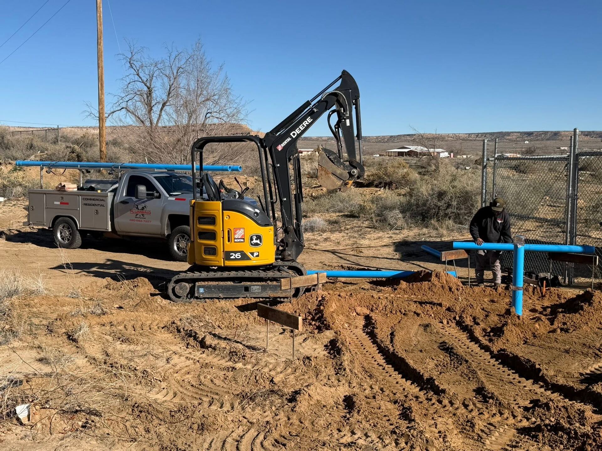 Smelter Town Plumbing truck and excavator on a water line job