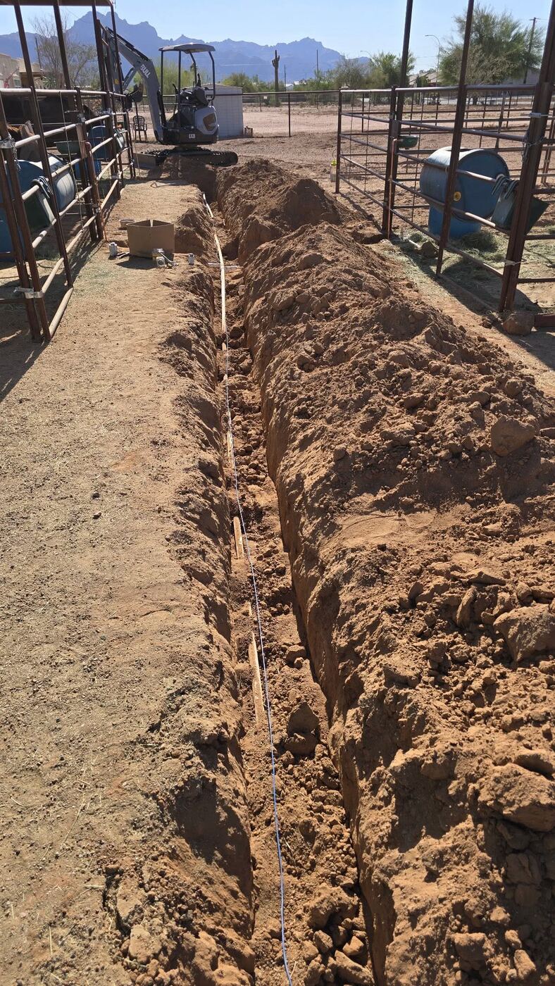 Water line trench between horse stalls