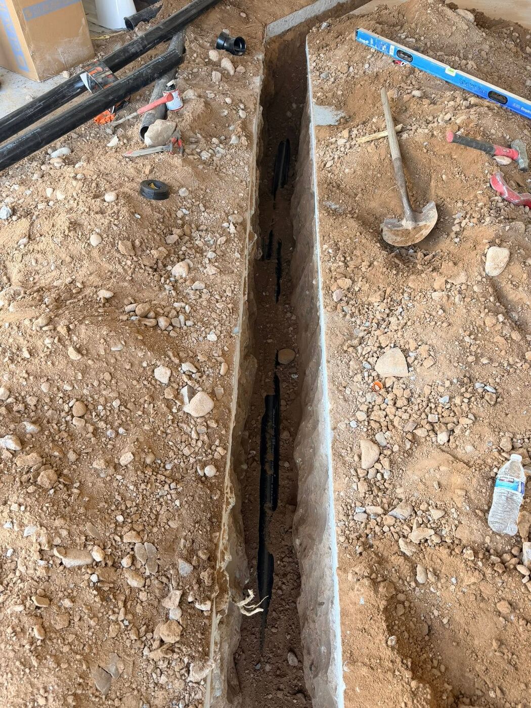 Under-slab residential repipe trench